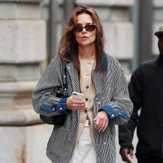 Katie Holmes wearing a vest and sunglasses in NYC