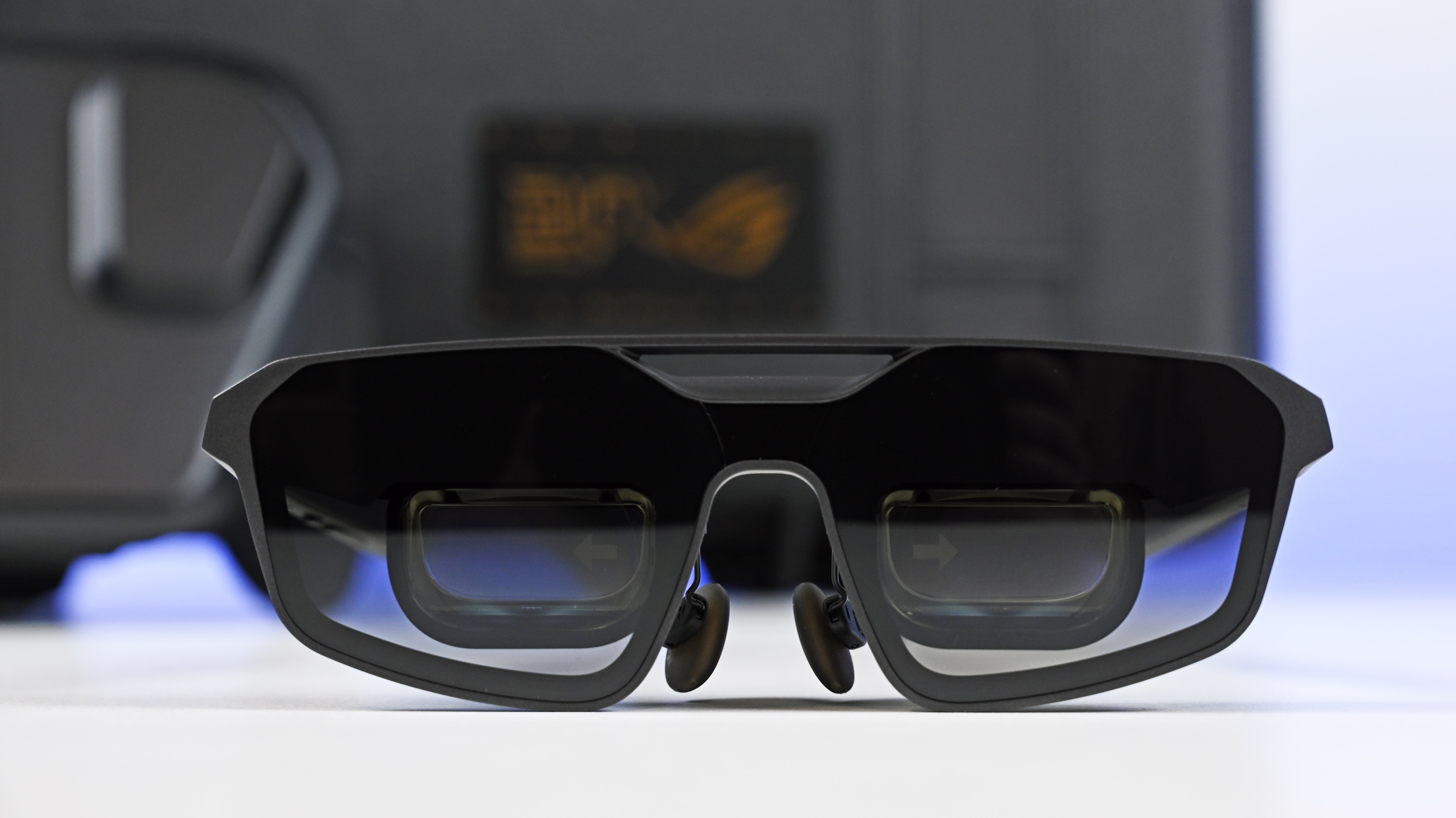 Front view of the matte black ROG XREAL R1 Edition 20 AR glasses, highlighting the tinted lenses and dual display prisms.