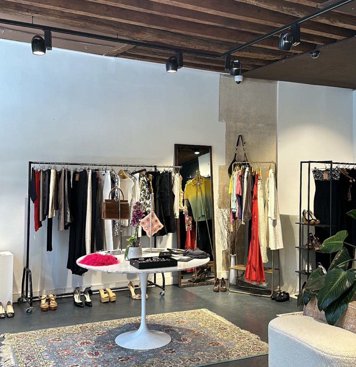 Clothing and accessories displayed inside Palace Callas, one of the best vintage stores in Paris.