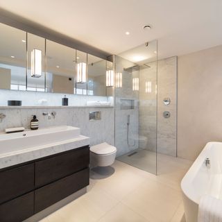 ellie goldings house bathroom with glass shower room white bath tub and wash basin