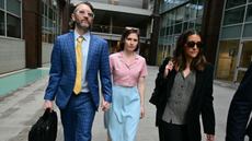 Amanda Knox and her husband Christopher Robinson walk outside a courthouse in Florence