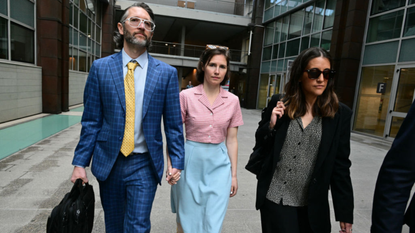 Amanda Knox and her husband Christopher Robinson walk outside a courthouse in Florence