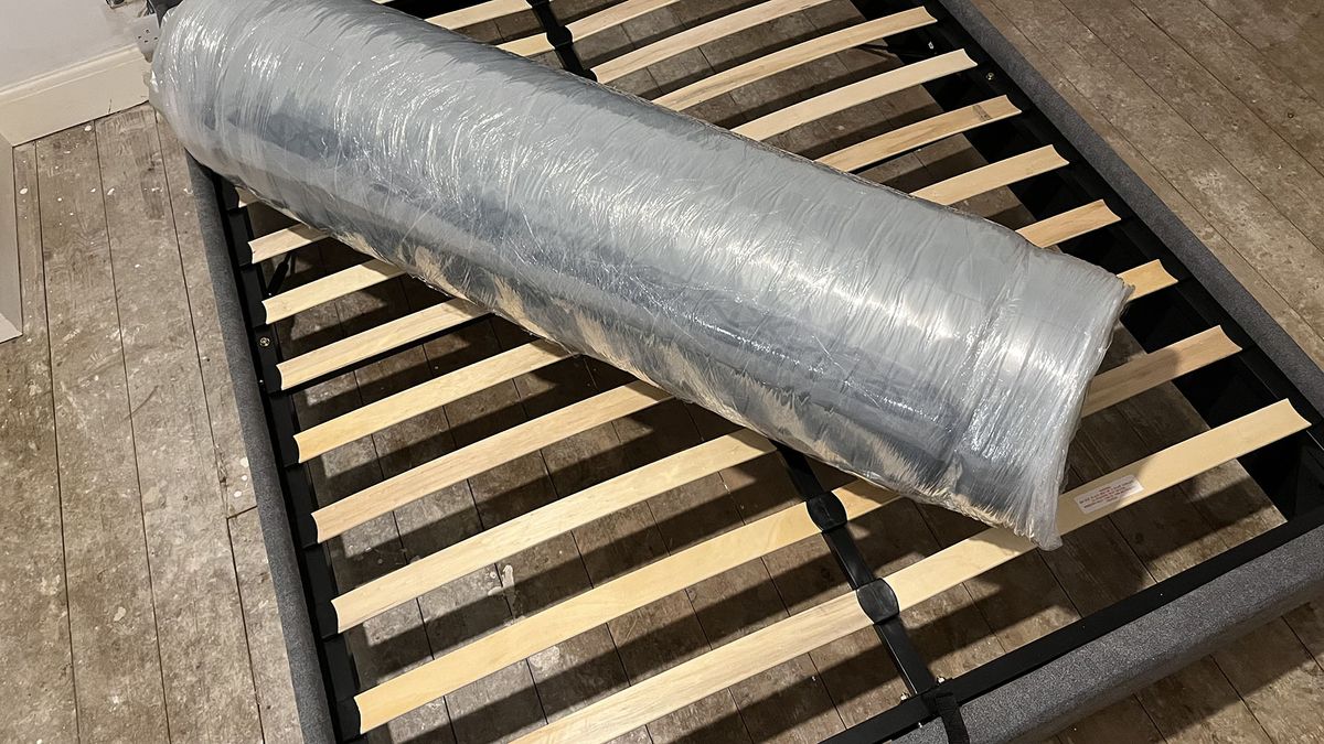 Zoma Hybrid mattress vacuum-packed and rolled on bed frame