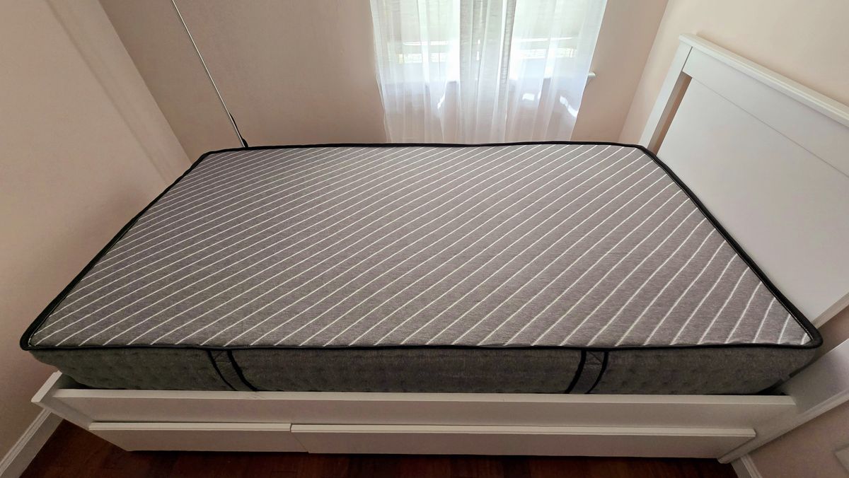 Overview of the Siena Premier Hybrid Mattress in a warm-hued bedroom on a white bed frame with a headboard