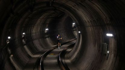 A participant runs through the subway tunnel during a race to commemorate the 100th anniversary of the Barcelona metro, in Barcelona, Spain