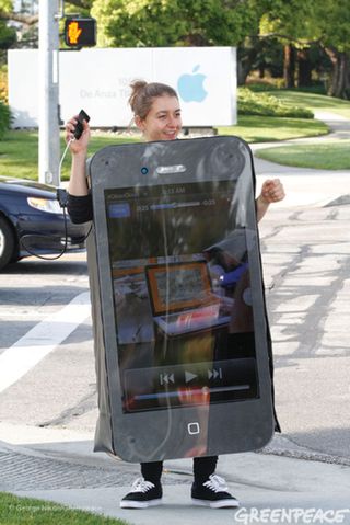 A Greenpeace activist displaying messages for the Apple employees