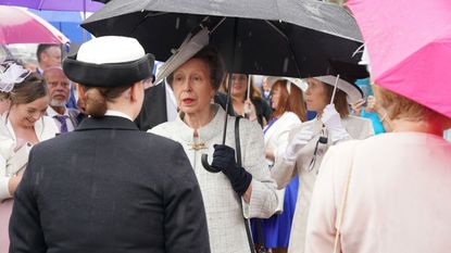 Princess Anne's pale gray coat was perfectly matched to the weather in Scotland as the Princess joined the King and Queen at a garden party