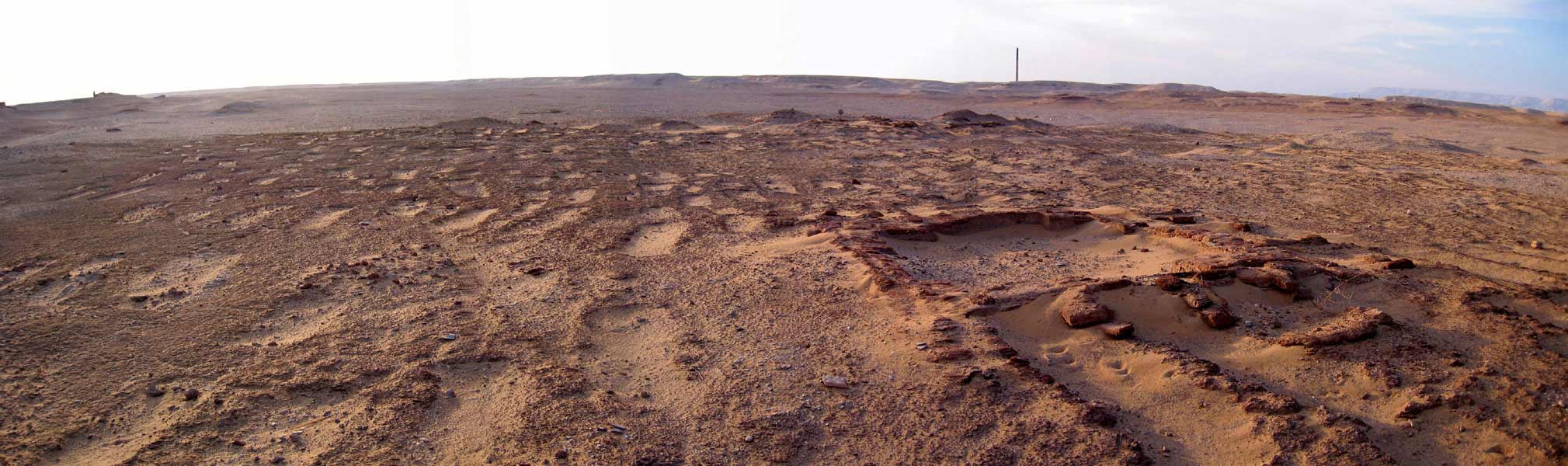 The remains of tomb structures discovered in an ancient Egyptian cemetery that have been heavily eroded from the wind and passage of time.