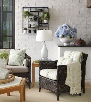 small sunroom with white walls and black furnishings