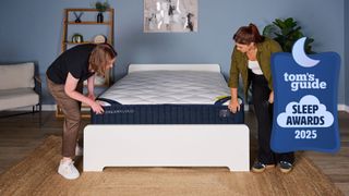 Two women set up the DreamCloud Classic mattress with a Tom's Guide Sleep Awards 2025 badge overlaid