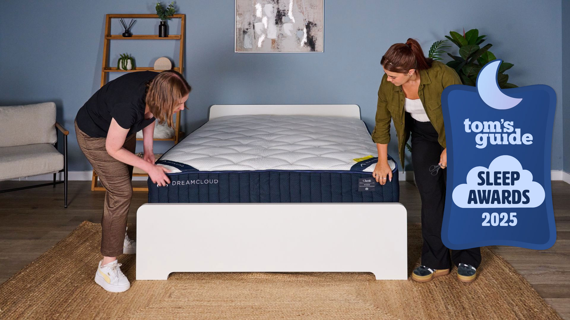 Two women set up the DreamCloud Classic mattress with a Tom's Guide Sleep Awards 2025 badge overlaid