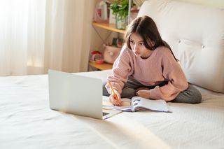 Teenage girl working from home during the lockdown