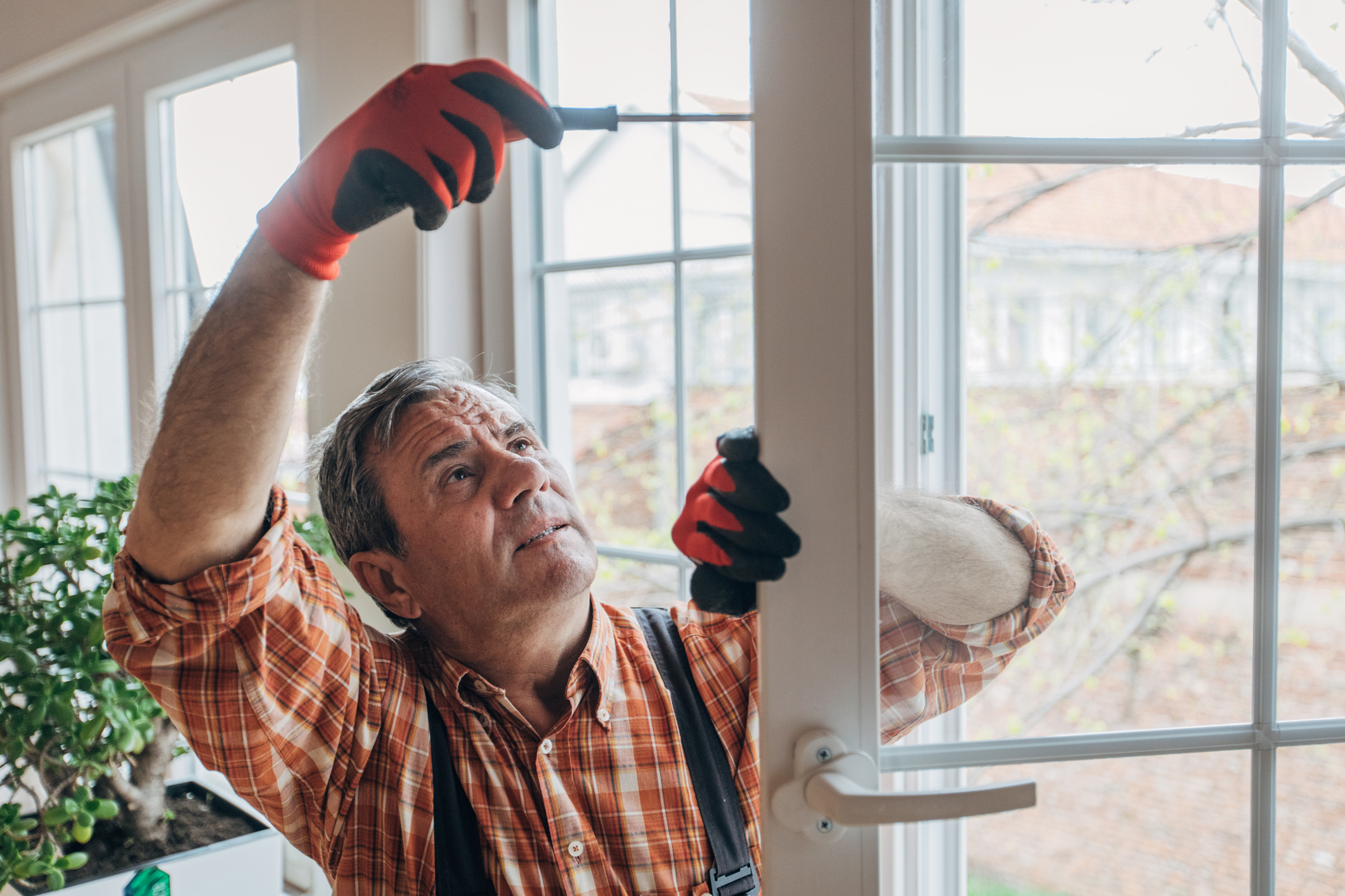 A man installing a new window in a home