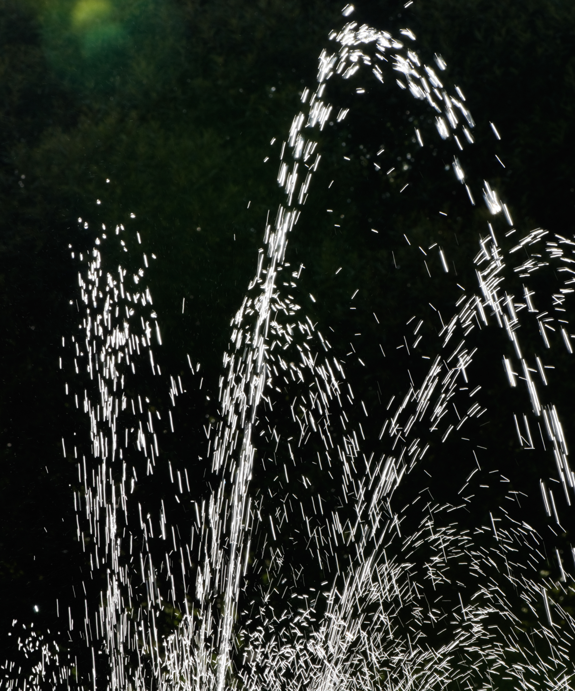 Close-up of illuminated fountain water spraying at night