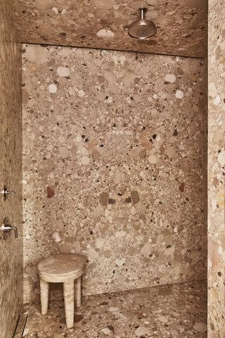 A shower room designed in highly veined marble