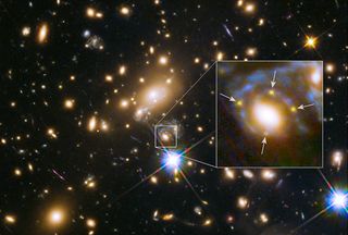 In this Hubble Space Telescope image, the many red galaxies are members of the massive MACS J1149.6+2223 cluster, which creates distorted and highly magnified images of the galaxies behind it. A large cluster galaxy (center of the box) has split the light from the distant supernova SN Refsdal, which lies in a magnified background galaxy, into four yellow images (arrows) to form an Einstein Cross. 