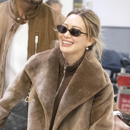 Hilary Duff wearing a brown outfit at the airport in Toronto