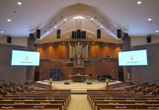 The stage of a house of worship brought to life sonically by an L-Acoustic PA system.