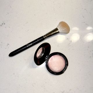 Dior makeup brush next to Pat McGrath pink powder
