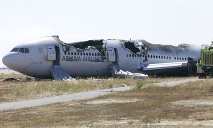 The wreckage of Asiana Airlines flight 214 lies near the runway following Saturday's crash in San Francisco.