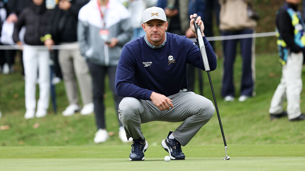 Bryson DeChambeau lines up a putt on the green