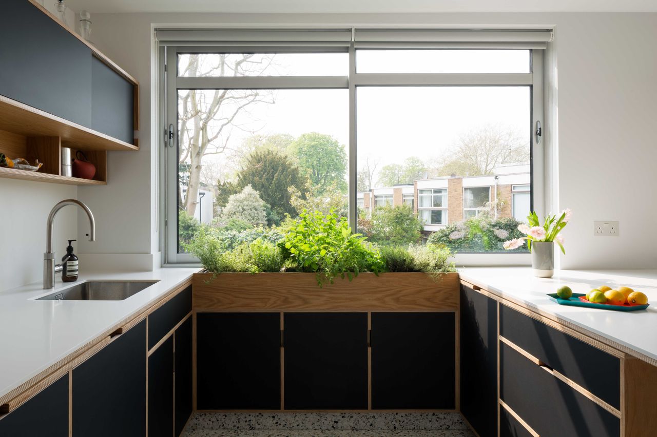 modern black kitchen with inbuilt kitchen window planter