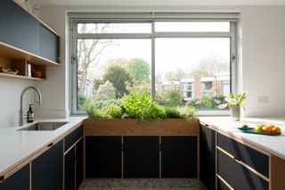 modern black kitchen with inbuilt kitchen window planter