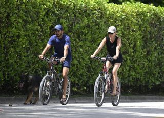 Gisele and Joaquim Valente riding bikes outside