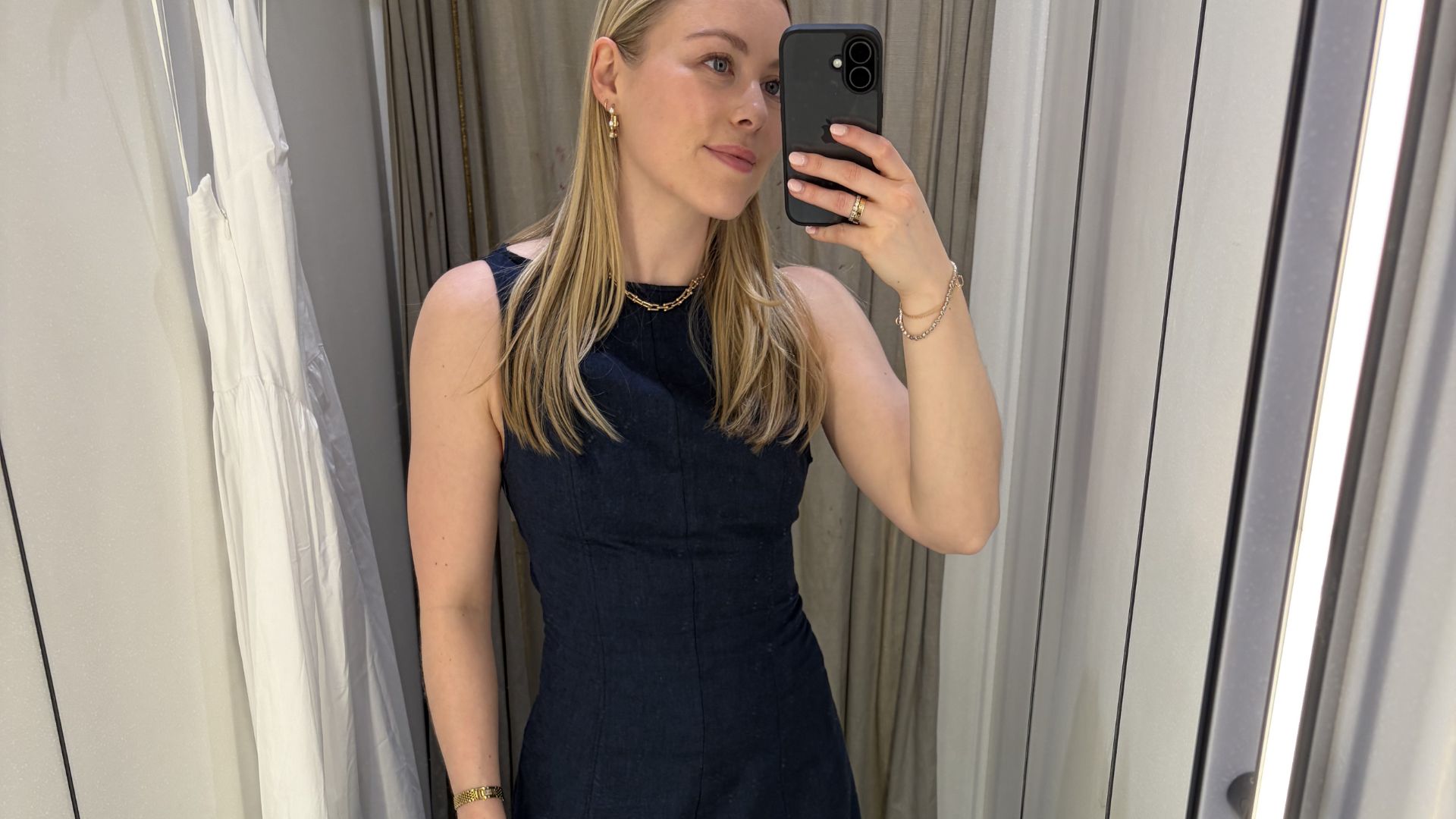 Woman wears navy linen dress from Zara