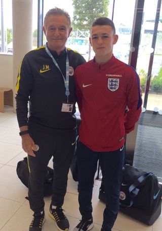 Phil Foden with his former youth team coach Joe Makin Handouts Photos