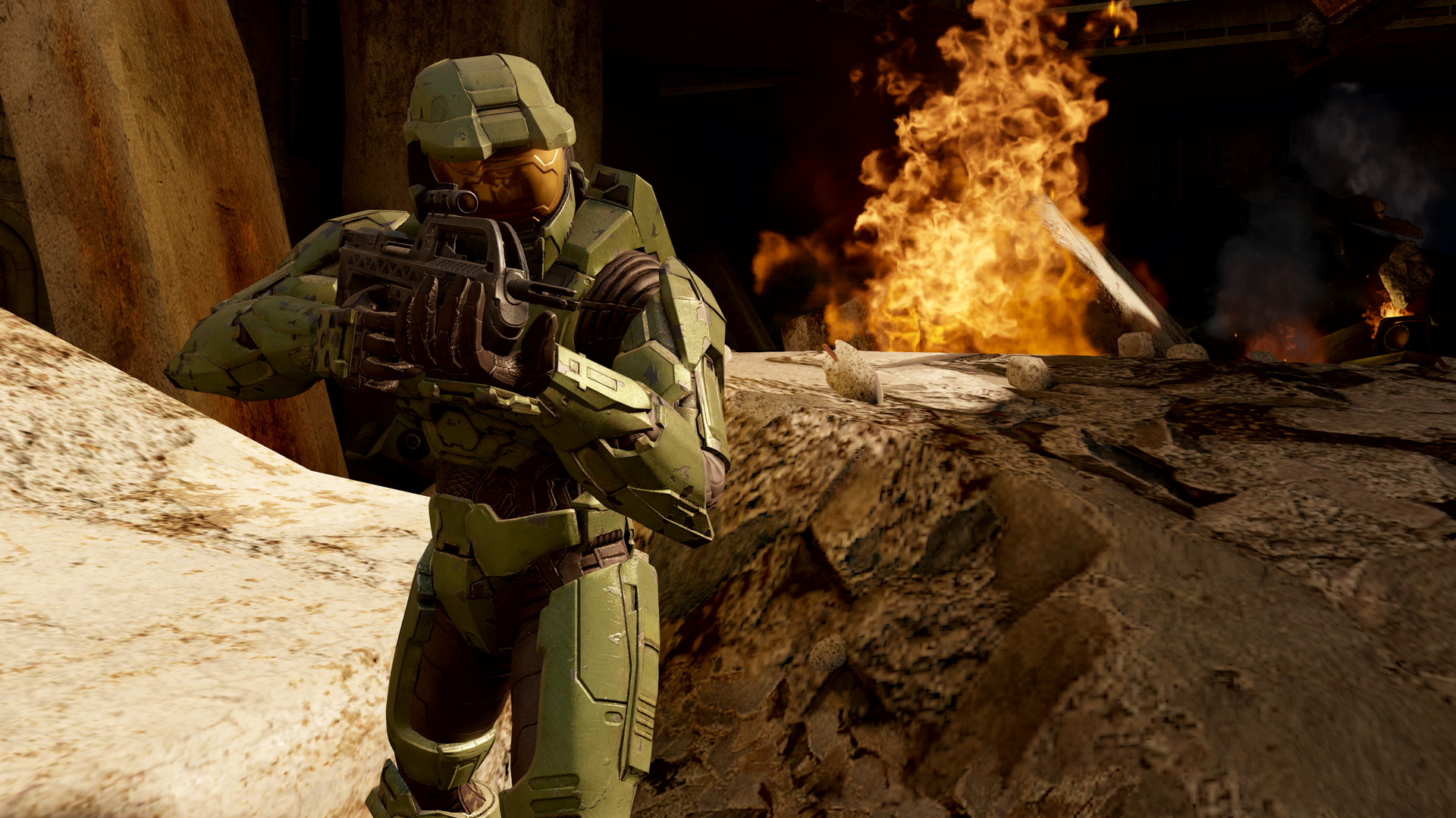 Master Chief charges with a rifle as a fire burns behind him in FPS Halo 2