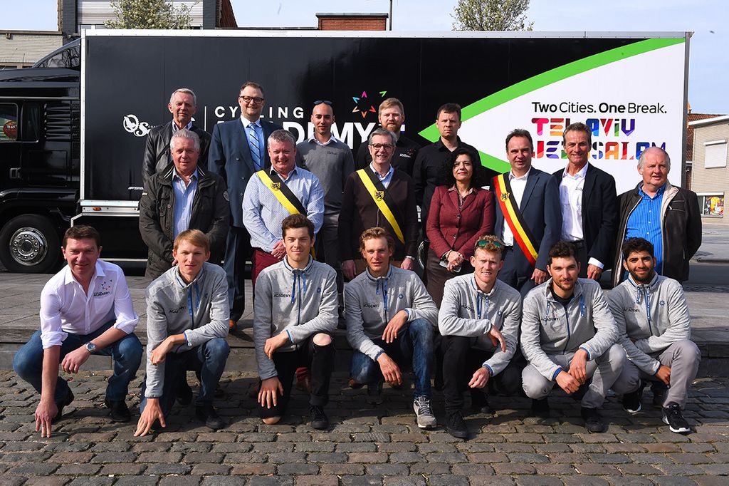 Riders, team staff and dignitaries pose for photos