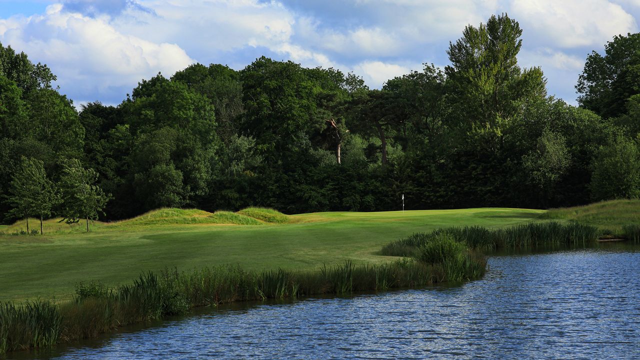 The Springs Resort &amp; Golf Club green pictured over a lake