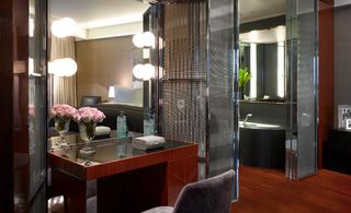 Mirrored surfaces abound in the 85 guest rooms