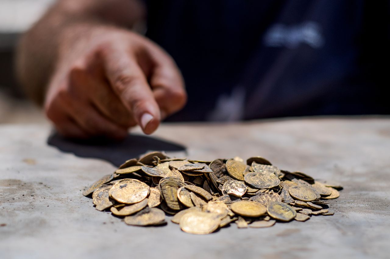 The pile of gold coins that were found in a buried clay jar.