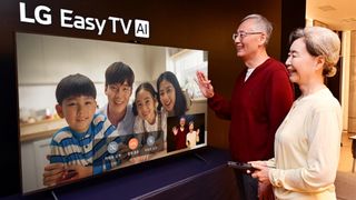 Two seniors making a video call to four children on an LG Easy TV