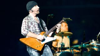 The Edge playing on stage with U2