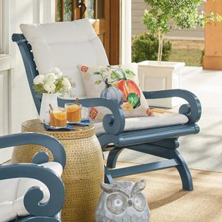 front porch with a rocking chair accessorised with a pumpkin cushion