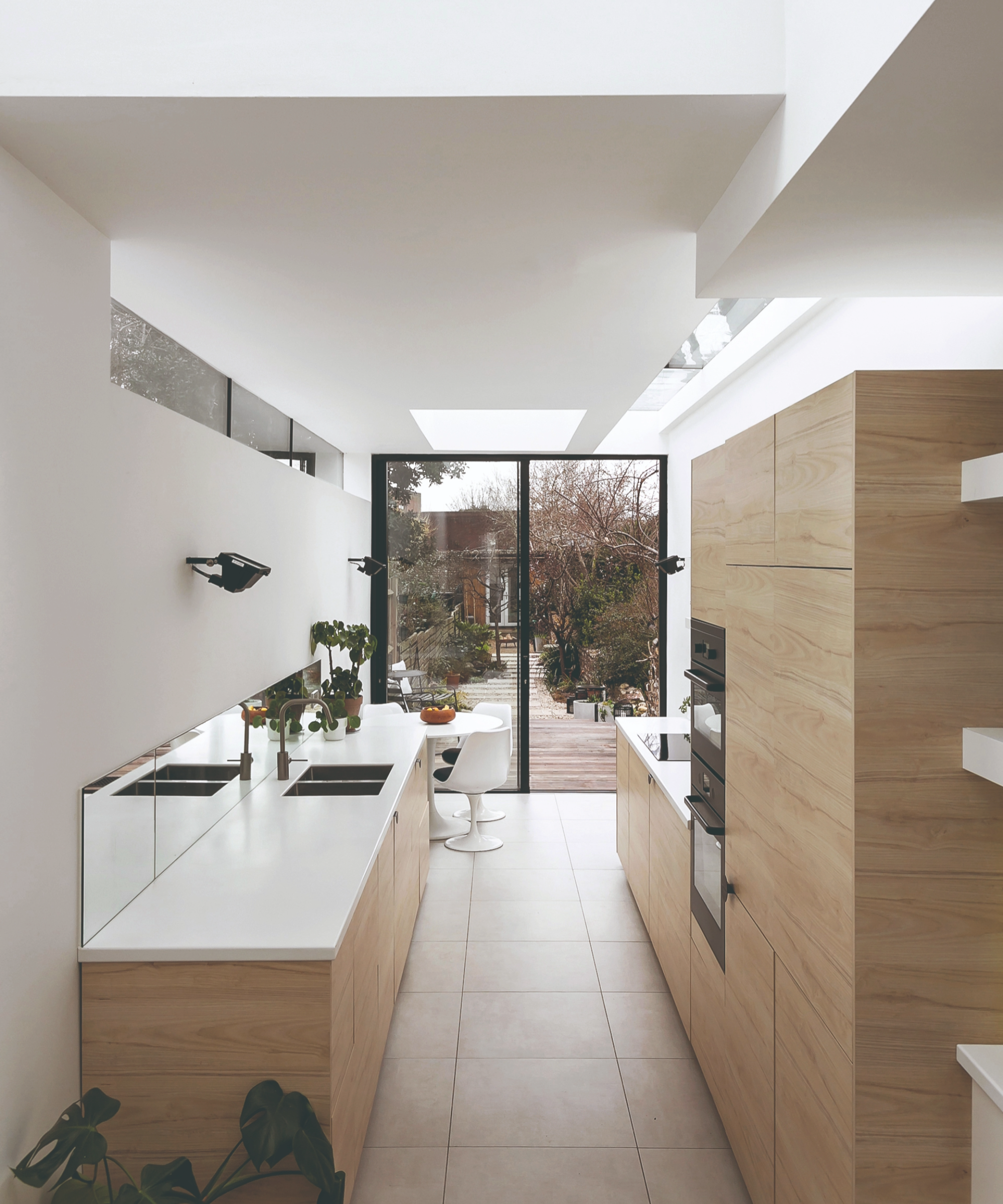 View from the top of the narrow kitchen with the garden door at the end