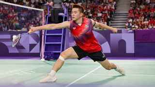  Kunlavut Vitidsarn of Team Thailand, in red shirt and black shorts, competes during the Men's Singles Badminton at the 2024 Olympic Games.