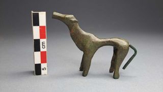 A bronze figurine, likely of a dog, from the excavation in Greece.