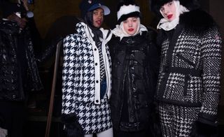Three models in plain black, and black and white jackets