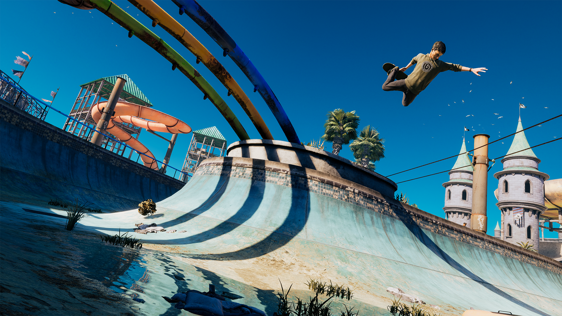 Screengrab from Tony Hawk&#039;s Pro Skater 3 + 4 showing a skateboarder in mid-air over a skate park with blue skies