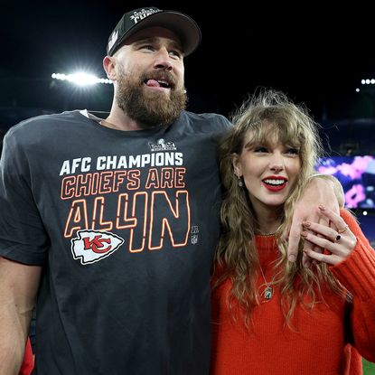 Travis Kelce of the Kansas City Chiefs celebrates with Taylor Swift after a 17-10 victory against the Baltimore Ravens in the AFC Championship Game at M&T Bank Stadium on January 28, 2024 in Baltimore, Maryland.