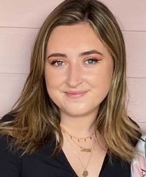 A portrait of Molly from the Ideal Home team, smiling and showcasing her iced-coffee obsession.