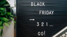 A black board with the words Black Friday 3 2 1 go! written on it.