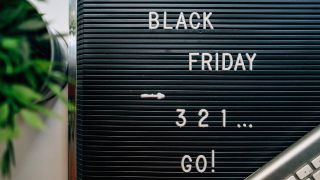 A black board with the words Black Friday 3 2 1 go! written on it.