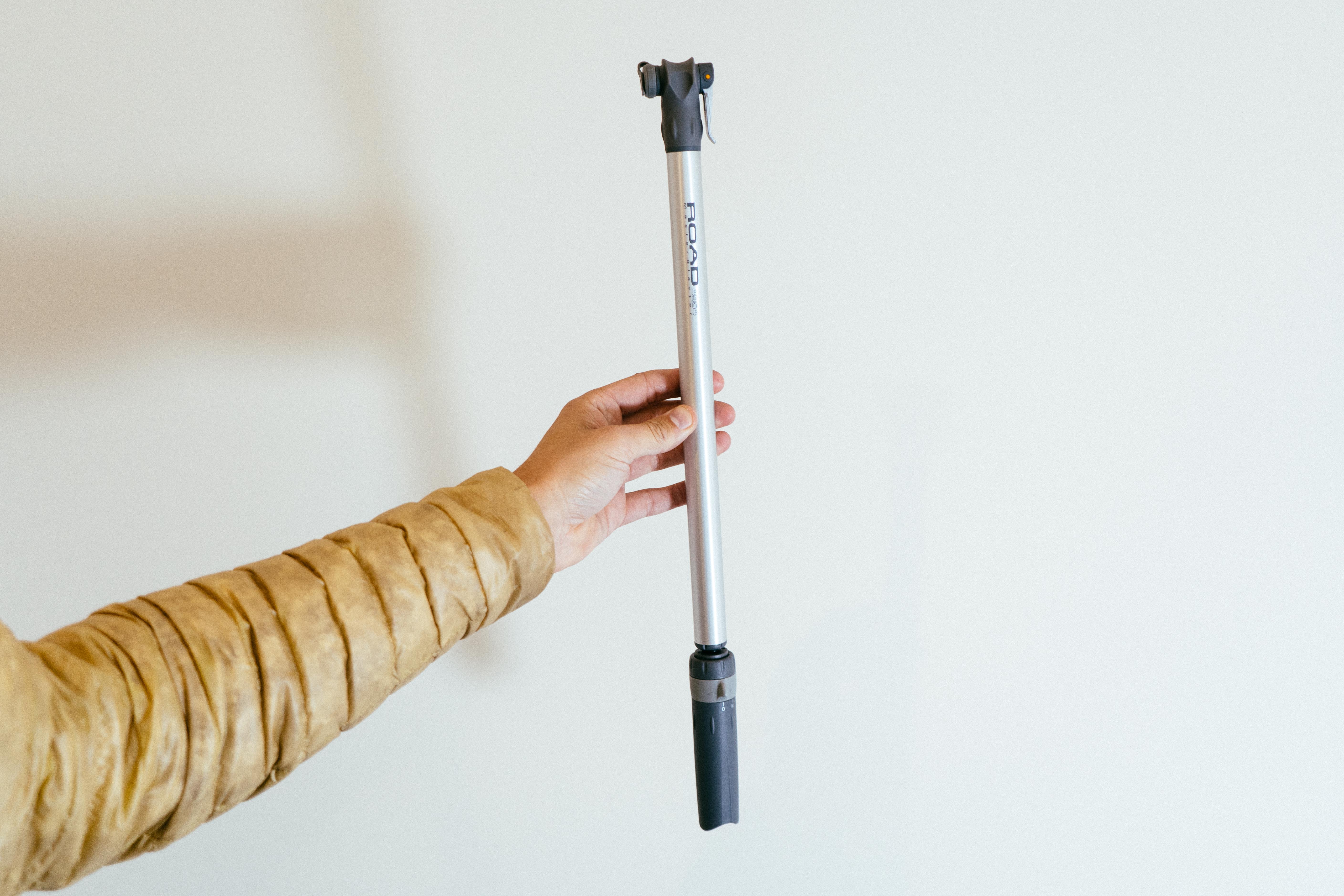 A long silver bike pump held vertically