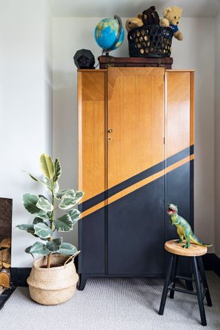 A wooden wardrobe with a customised black painted on design