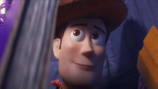 Woody looking up from inside a backpack with a knowing smile in Toy Story 4.